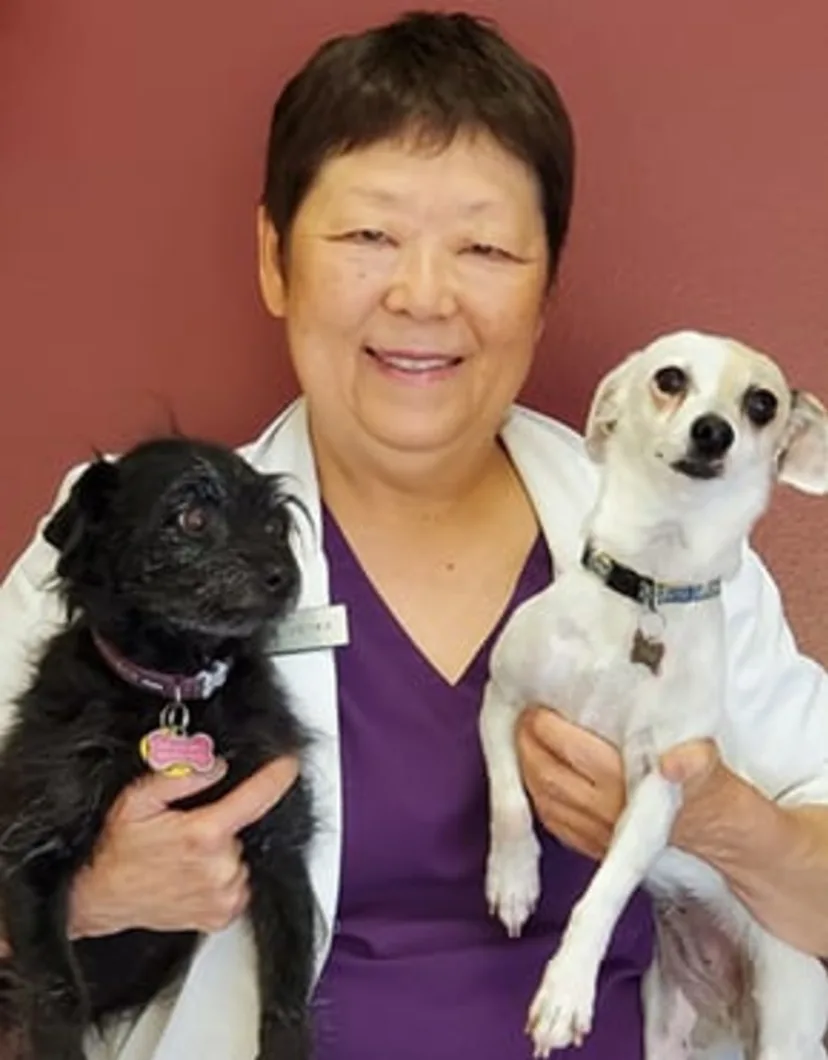 Dr. Lynn Vieyra holding two dogs